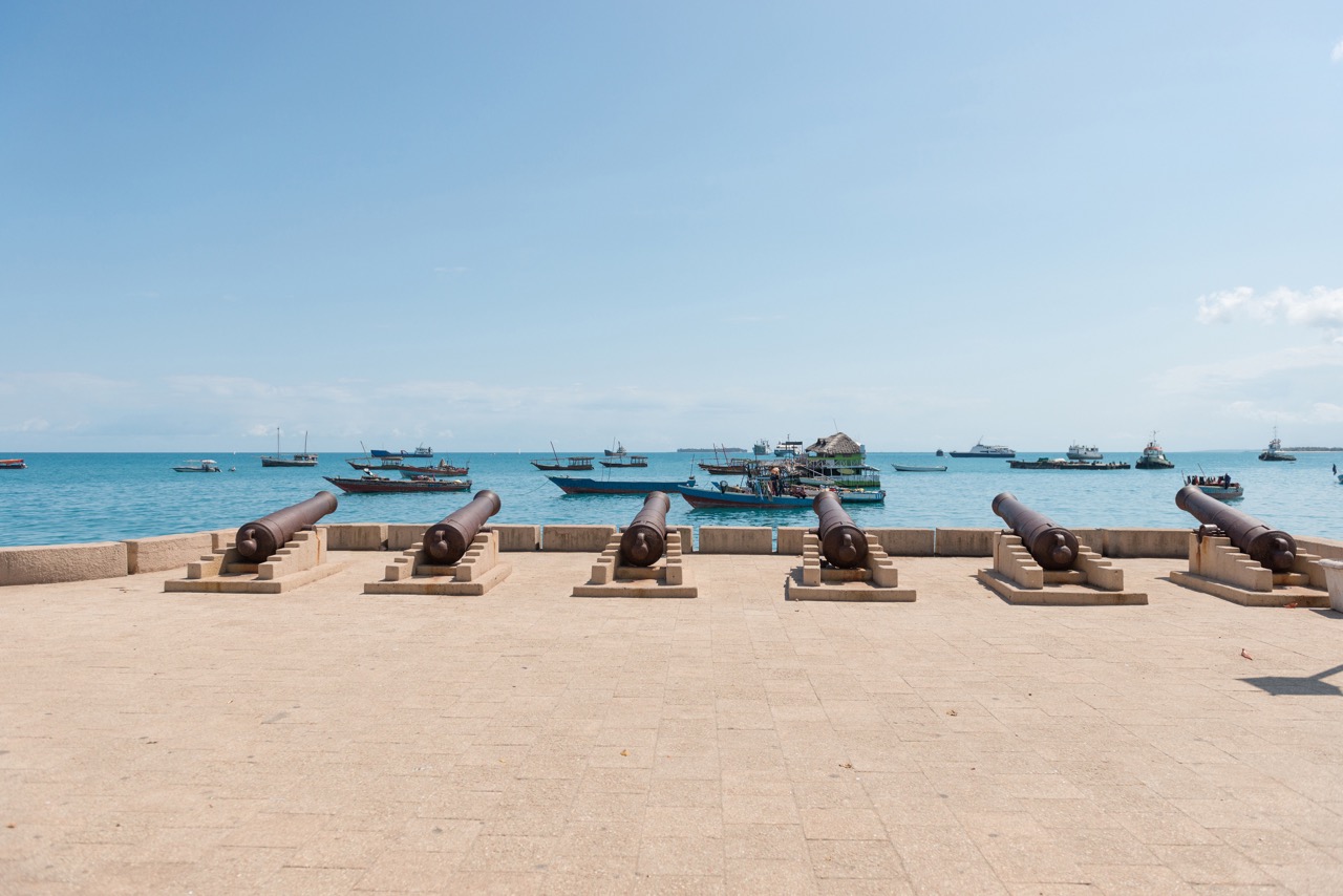 waterfront-of-stone-town-with-cannons-in-zanzibar-2023-01-04-19-18-18-utc Large